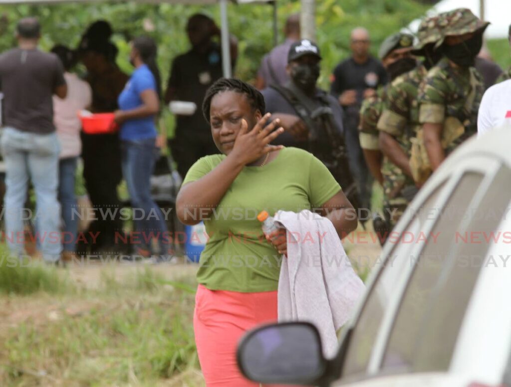 Kimberly Charles wipes away her tears as she leaves the site where her two-year-old son Kimani Francis was found in Techier Village, Port Fortin on Tuesday.  Photo by Ayanna Kinsale