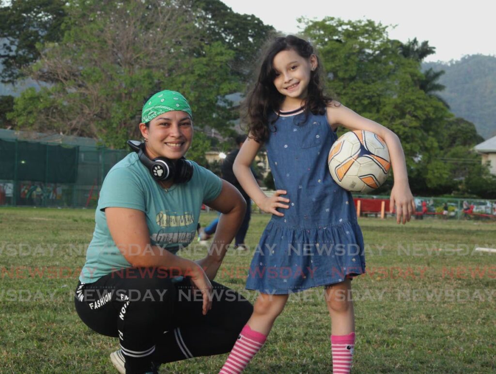 Valeria Figueiras and her mother Yohannis Ruiz, a kickingball player, at Nelson Mandela Park, St James. Photo by Roger Jacob