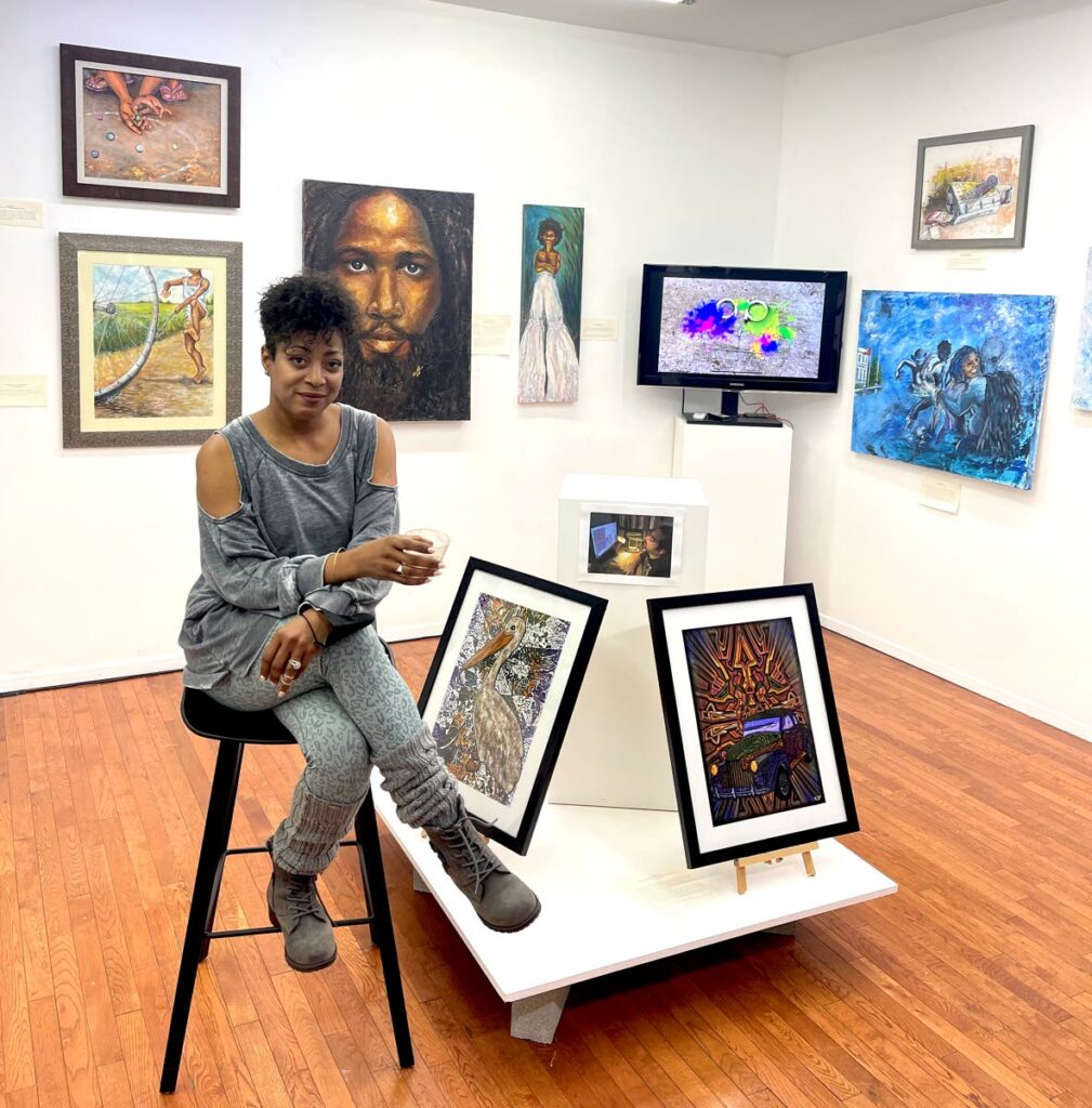 Artist Alicia Aberdeen with a few pieces of her exhibit in New York in 2021, Paintings in the Garden, including a portrait of David Rudder. Photo courtesy Alicia Aberdeen