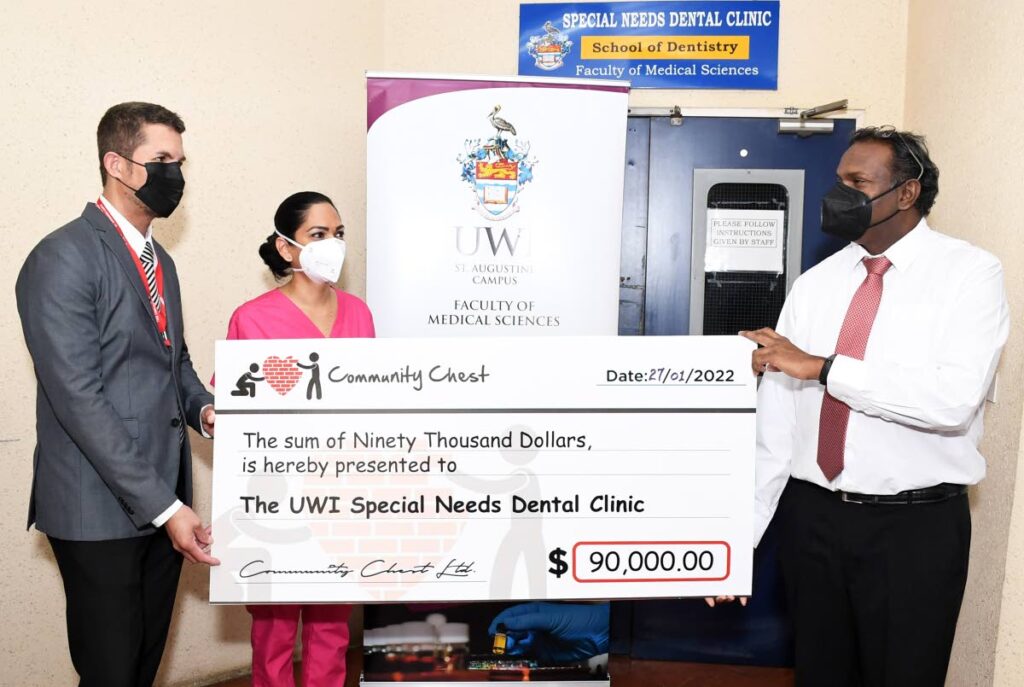 HELP: From left, Dr William Smith, Director of the School of Dentistry, UWI, St Augustine campus and Dr Ramaa L. Balkaran, lecturer in special needs dentistry and co-ordinator of The UWI Special Needs Dental Clinic, accepts a donation from Louis Ramdhanie, Director of Community Chest Limited. PHOTO COURTESY THE UWI 

  - The UWI