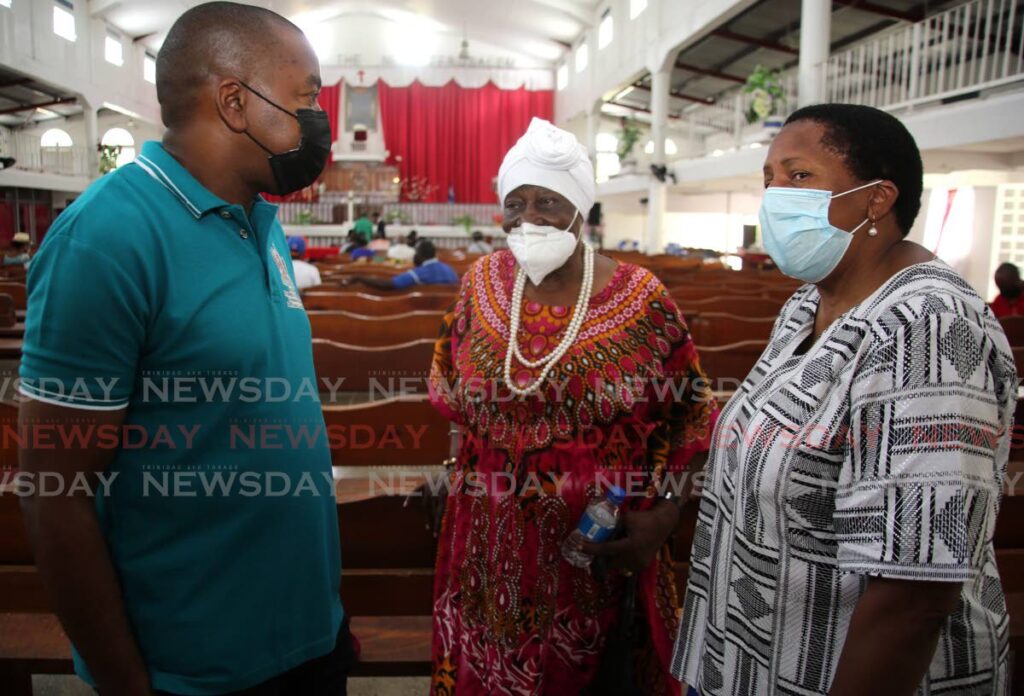 Government MPs Foster Cummings and Pennelope Beckles chat with 91-year-old farmer Willhimea Benn during land tenure consultations at Solomon Temple, Wallerfield on Saturday. Photo by Sureash Cholai