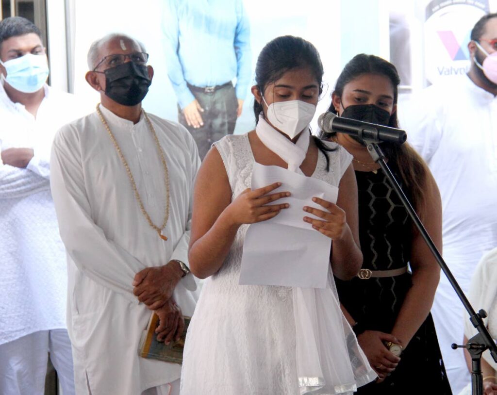 Hailey Dindial pays tribute to her father, businessman Darryl Dindial, who was shot dead on May 5, during a funeral service at his auto supplies store in Montrose on Saturday. - AYANNA KINSALE