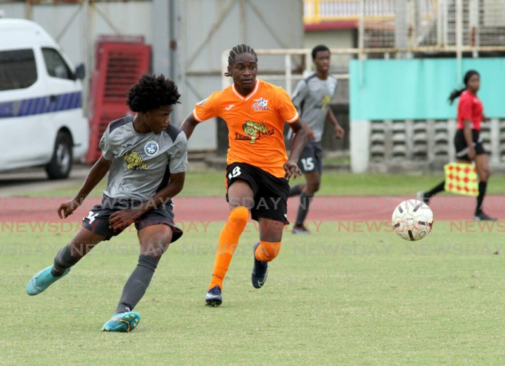 Jayden Moore (left) of Police Youths and Jabari Forbes of Club Sando vie to get control of the ball during their Tiger Tanks Under-20 Invitational Tournament, at the Manny Ramjohn Stadium, Marabella on Saturday. - AYANNA KINSALE