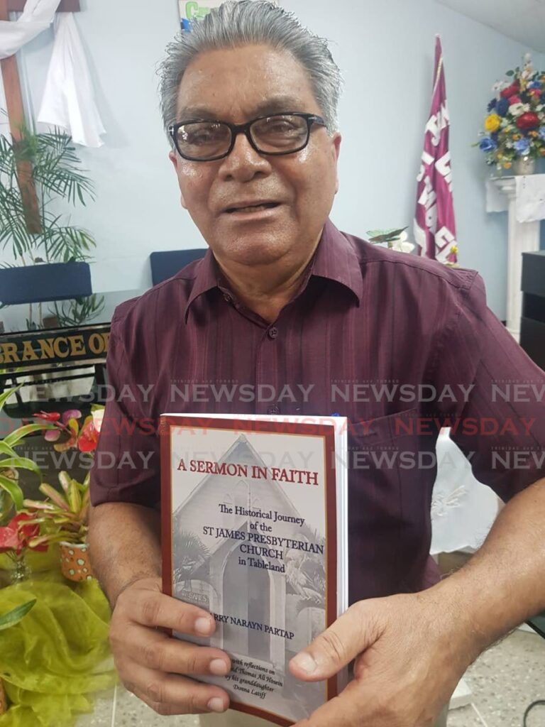 Partap holds a copy of his second book  - A Sermon in Faith which focuses on the S James Presbyterian Church in Tableland. Photo by Yvonne Webb