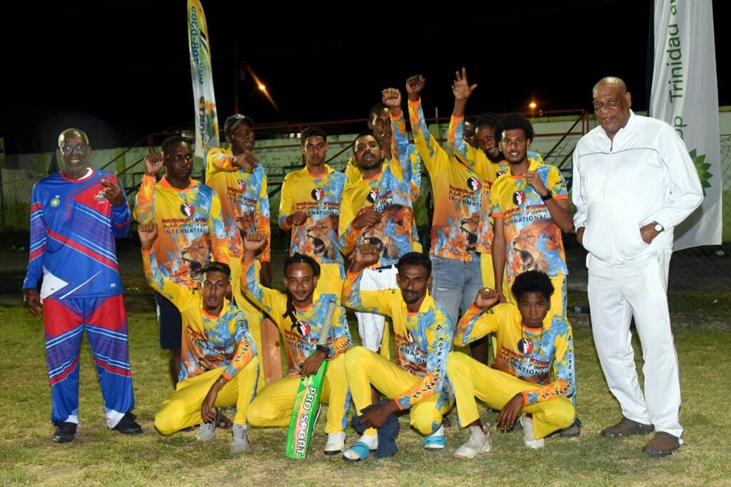 AMSF chairman Bartholomew Lynch (left) and bpTT community liaison officer Matthew Pierre (right), celebrate with the team More Fire after their victory in the round-robin tournament on May 7.   Photo courtesy Benchmark Communications