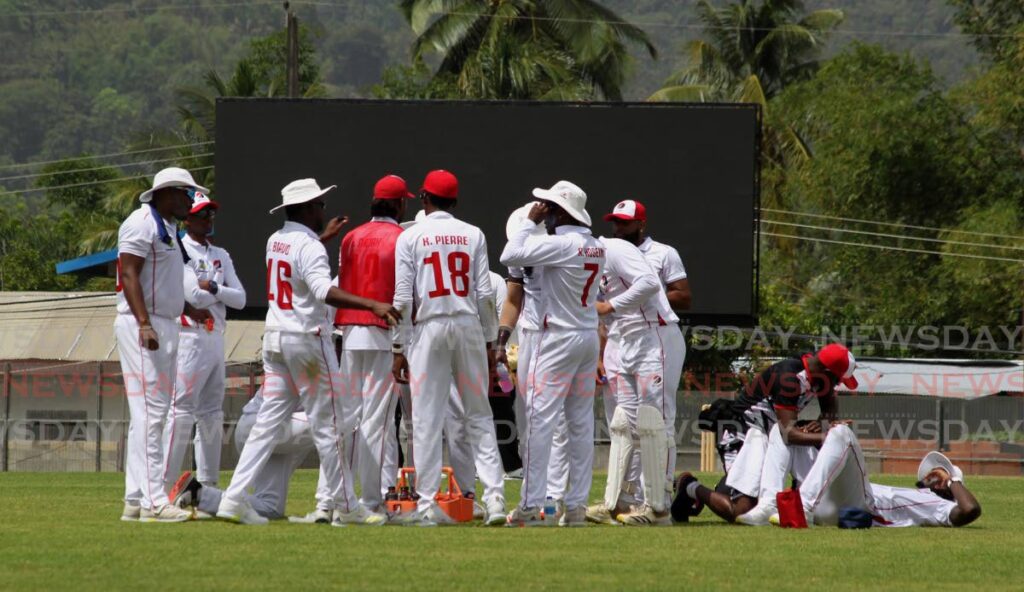 Red Force players huddle during a water break in their four-day match against the Leeward Islands Hurricanes at the Diego Martin Sporting Complex last week. Photo by Roger Jacob