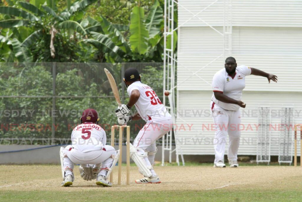 Red Force batsman Bryan Charles faces a delivery from Leeward Islands Hurricanes captain and off-spinner Rahkeem Cornwall (right), while Hurricanes wicketkeeper Amir Jangoo (left) looks on, during their third round match at the Diego Martin Sporting Complex on Thursday. - AYANNA KINSALE