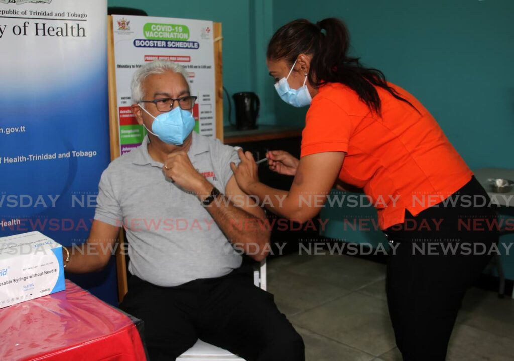 Health Minister Terrence Deyalsingh receiving his second covid19 vaccine booster shot from NWRHA head nurse Vannessa Siblal at the Paddock of the Queen's Park Savannah in Port of Spain. - SUREASH CHOLAI