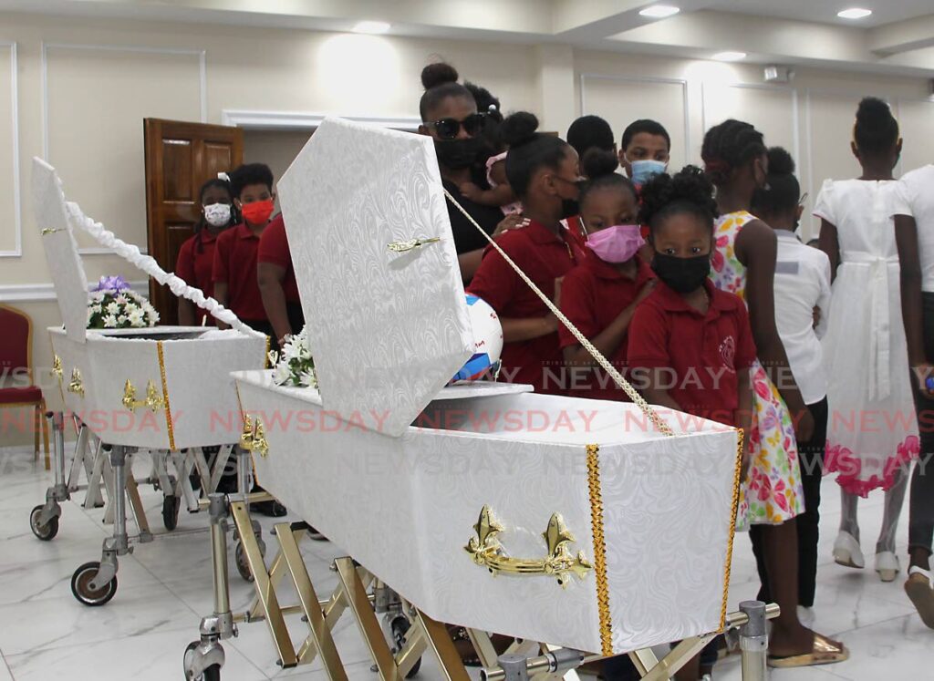 Levi Lewis's former schoolmates from St Dominic's RC Primary School pay their final respects at a funeral for Lewis and his mother, Abeo Cudjoe, at Boodoo Funeral Chapel, SS Erin Road, Penal on Friday. - Photo by Roger Jacob