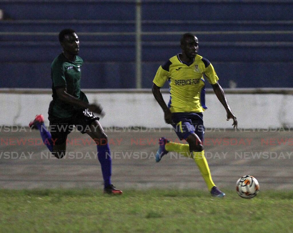 Defence Force's Jelani Felix (right) dribbles with the ball past Josiah Joseph of Real West Fort United during their teams' match at the Arima Velodrome on Saturday. - AYANNA KINSALE