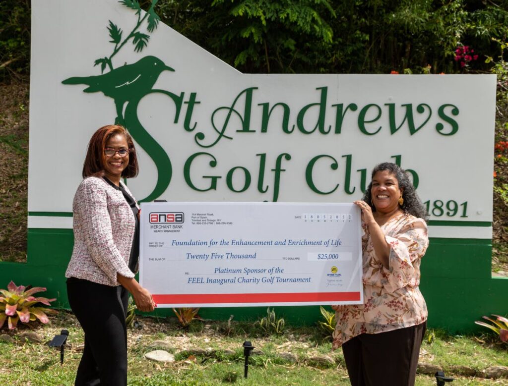 ANSA Merchant Bank's head of wealth management K. Ottley, left, presents FEEL CEO Elena Villafana Sylvester with a cheque for $25,000 for FEEL's inaugural Charity golf tournament in June.  - Courtesy ANSA Merchant Bank 