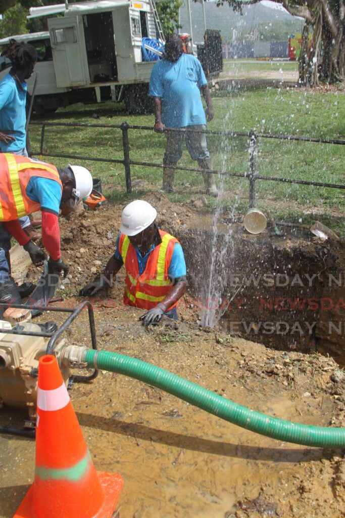 WASA work crew repairing the water leak along the jogger path near the exit at the Paddock in the Queen's Park Savannah in Port of Spain. Photo by Roger Jacob