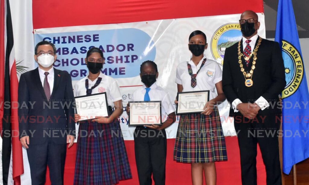 Chinese Ambassador Fang Qiu, from left, Karishma Ramdial of San Fernando West Secondary School, Daniel Garcia of St Paul's Boys'Anglican Primary School, Naomi Brown of Open Bible High School and San Fernando Mayor Junia Regrello at City Hall, San Fernando where the students received scholarships from the ambassador on Friday. Photo by Yvonne Webb