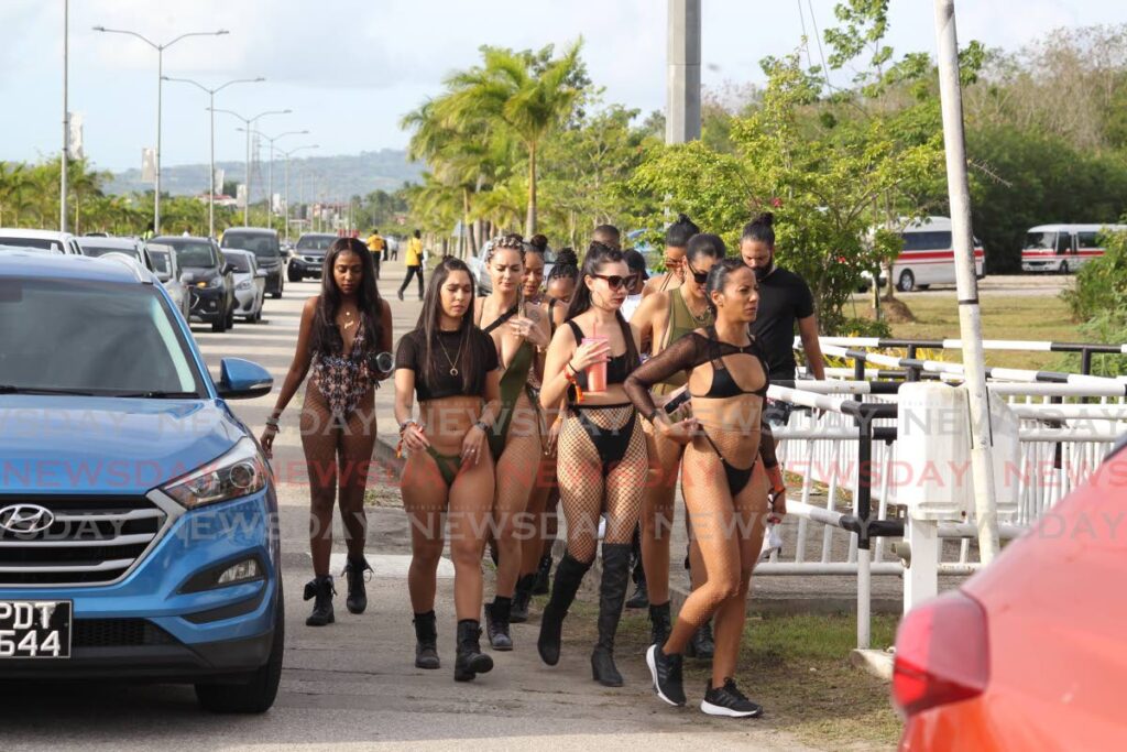 A group of women arrive at the Bacchanal Road fete, hosted by Caesar's Army Ltd, on Sunday at the Brian Lara Cricket Academy in Tarouba. - Roger Jacob