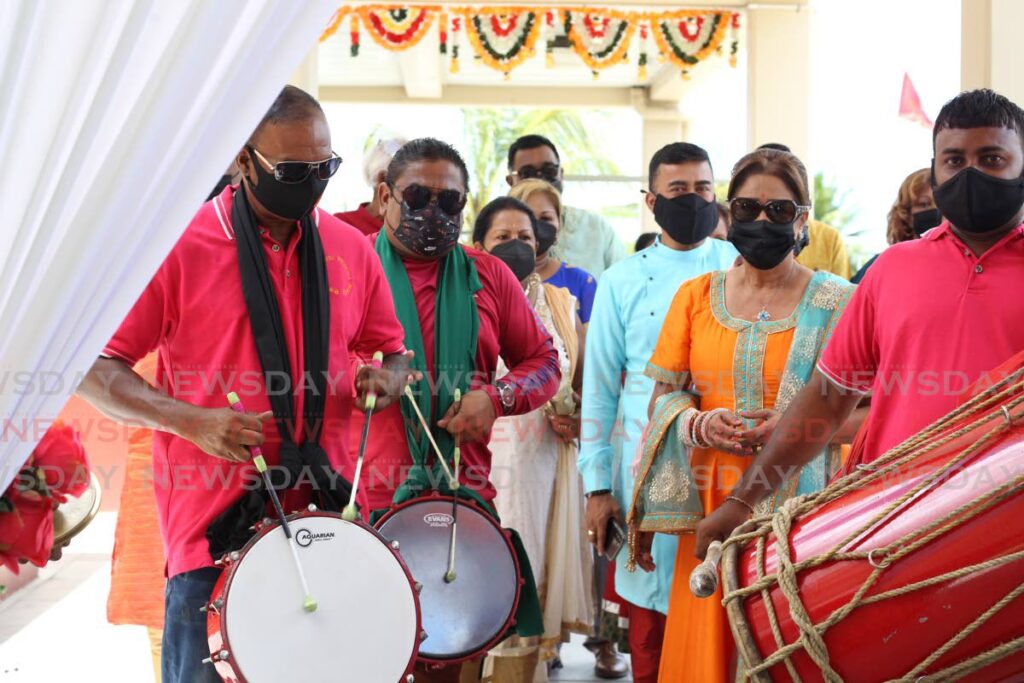 Opposition Leader Kamla Persad-Bissessar is accompanied by tassa drummers as she assrives at the Penal Rock Hindu Primary School on Monday for Indian Arrival Day celebrations hosted by the Sanatan Dharma Maha Sabha. - Roger Jacob