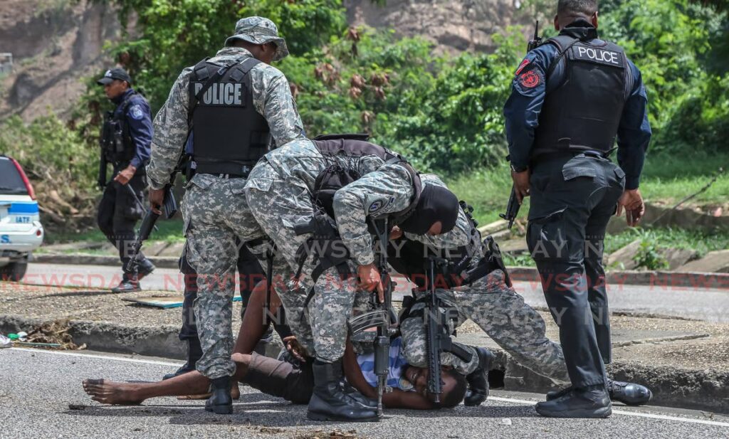 FILE PHOTO: Police apprehend a suspect in Port of Spain, June 30, 2020. Photo by Jeff Mayers