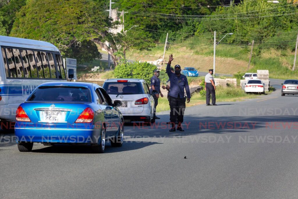 A policeman directs traffic during a road block exercise at Old Grange, Tobago. - File photo/David Reid