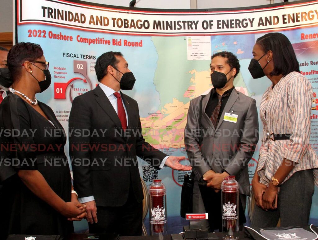 Minister of Energy and Energy Industries Stuart Young, second from left, chats with the permanent secretary, Penelope Bradshaw-Niles, left, acting senior petroleum engineer Christian Welsh and acting senior geologist Kimberly London at the TT Energy Conference, Hyatt Regency, Port of Spain on Tuesday. - AYANNA KINSALE