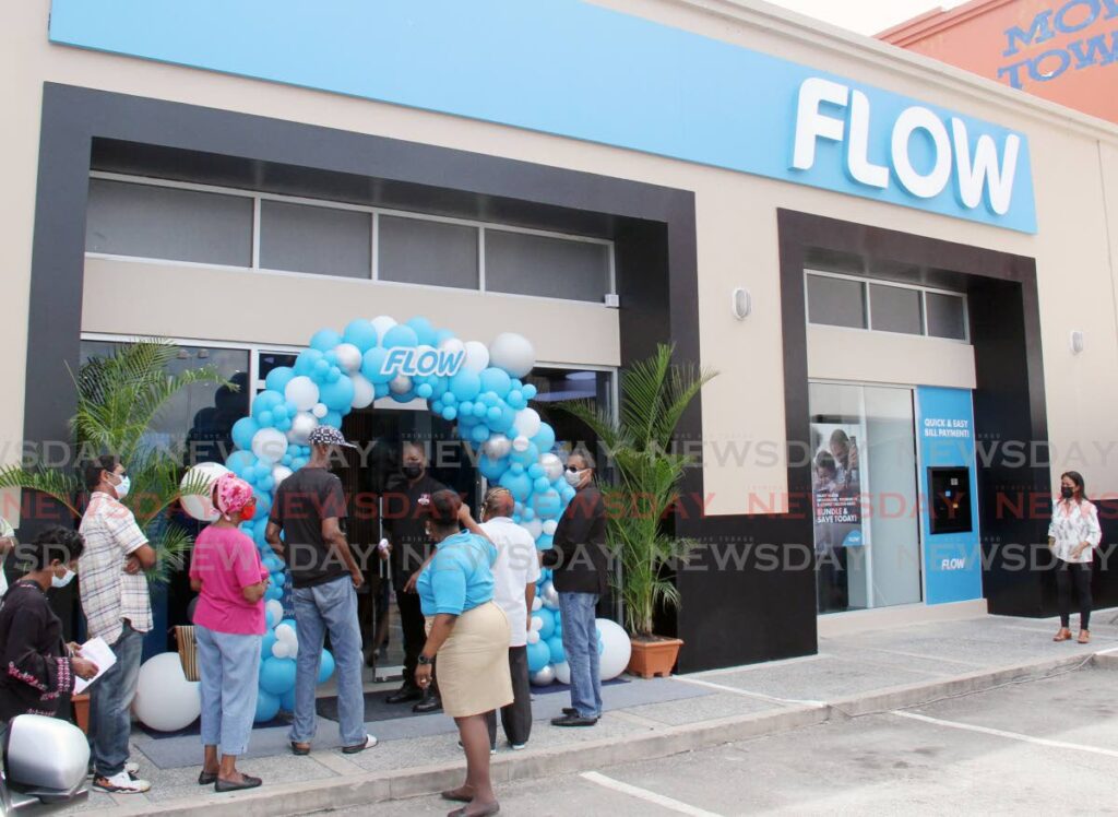 File photo of customers wait outside the newly-opened Flow retail store at Price Plaza, Chaguanas on Wednesday. - Lincoln Holder