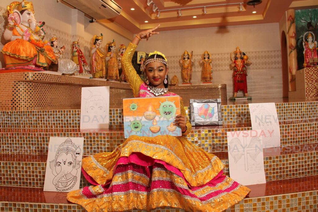 Dancer Aida Ramsahai with a collection of her drawings at the Chandrasekhar Vishnu Mandir in Rio Claro. - MARVIN HAMILTON