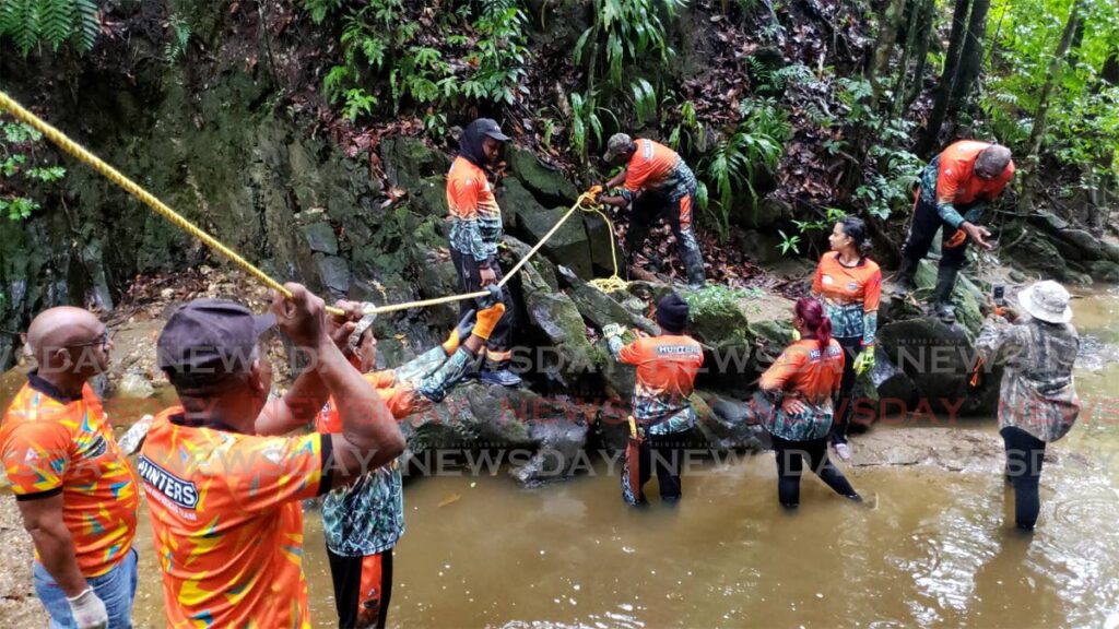 Hunters Search and Rescue team members anchor a guide rope in a river at the Heights of Aripo, Arima. - ROGER JACOB
