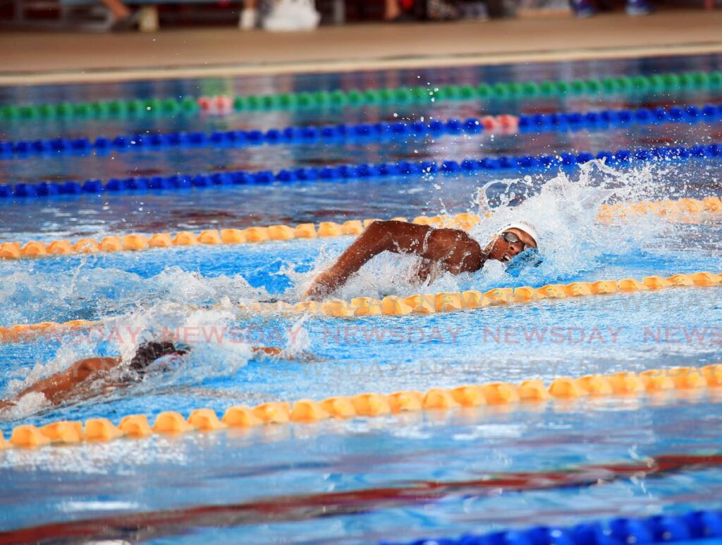 Nikoli Blackman (right) competes in the boys 15-17 4x200m relay at the Pan American Age Group Swimming Championships, at the National Aquatic Centre, Couva on Saturday. - Lincoln Holder