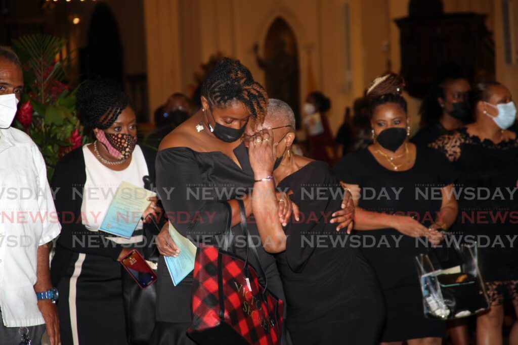 Mourners in grief at the funeral for ex-BP Renegades president Michael Marcano at the Cathedral of the Immaculate Conception on Monday. Photo by Sureash Cholai