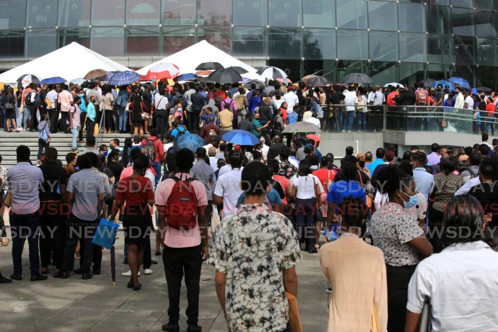 WAITING AND HOPING: In this file photo people outside NAPA, Port of Spain on Tuesday waiting to be interviewed for jobs on the Royal Caribbean's cruise-ships. Photo by Sureash Cholai