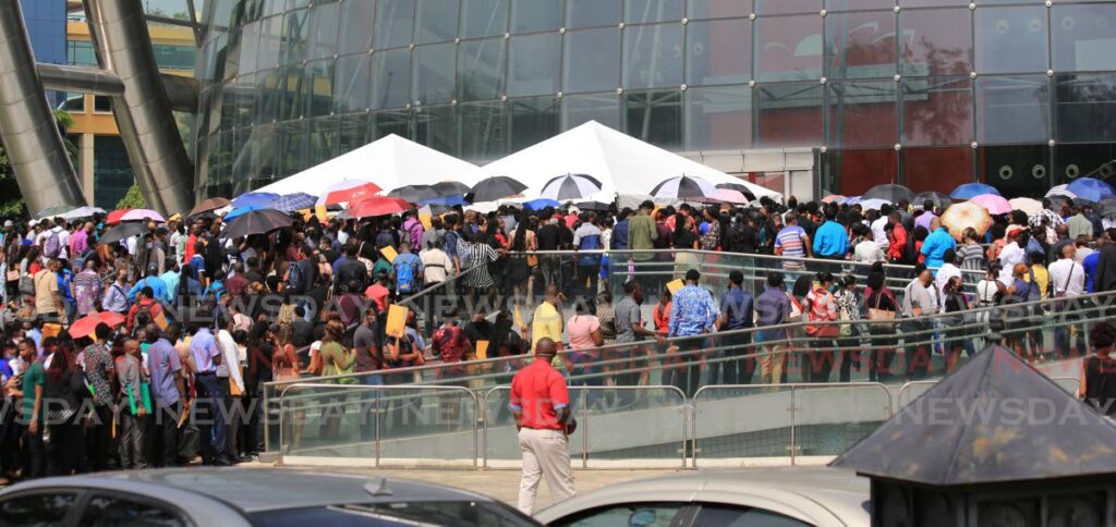 Hundreds line up for jobs with Royal Caribbean cruise line during a recruitment exercise at the National Academy for the Performing Arts in Port of Spain on June 7. - SUREASH CHOLAI