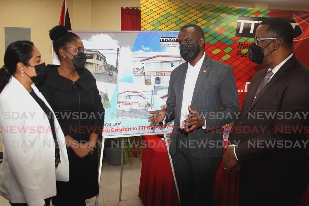 Minister of Public Utilities Marvin Gonzales (second from right) speaks with members of TTPost's board of directors Aliayah Hosein, Anatasia Samuel Jones, and deputy chairman Michael Seales at the reopening of the Gasparillo TTPost Postal Delivery Centre, Caratal Road, Gasparillo on Wednesday. - PHOTO BY ROGER JACOB