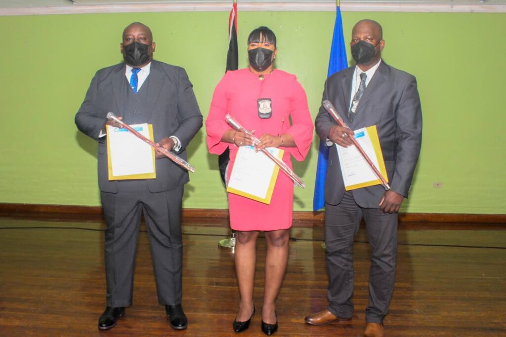 From left, Insps Brian Daniel, Allison Joseph and Erick Knutt with their instruments of appointment and canes at their promotion ceremony at the Police Administration Building, Port of Spain on Tuesday. PHOTO COURTESY TTPS - 