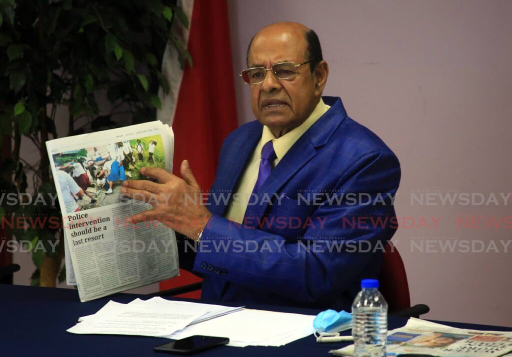 Former education minister Dr Tim Gopeesingh holds a copy of Sunday's Newsday during the Opposition's weekly news conference. - SUREASH CHOLAI