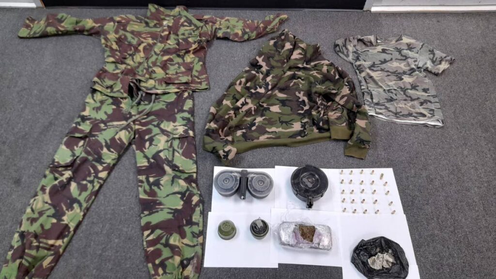 Police found and seized camouflage clothing, a grenade, ammunition and drugs while searching a bushy area in Couva on Saturday. 

PHOTO COURTESY TTPS - 