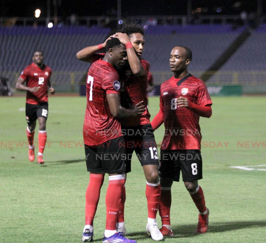 TT's Judah Garcia, centre, congratulates teammate Noah Powder, left, after he scored against St Vincent and the Grenadines during the Concacaf Nations League match, on Monday, at Hasely Crawford Stadium, Port of Spain.  - Photo by Roger Jacob