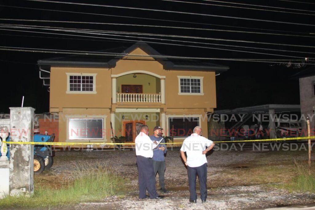 Police at the scene of a double homicide at St Mary's Village, Moruga, on Wednesday. - LINCOLN HOLDER