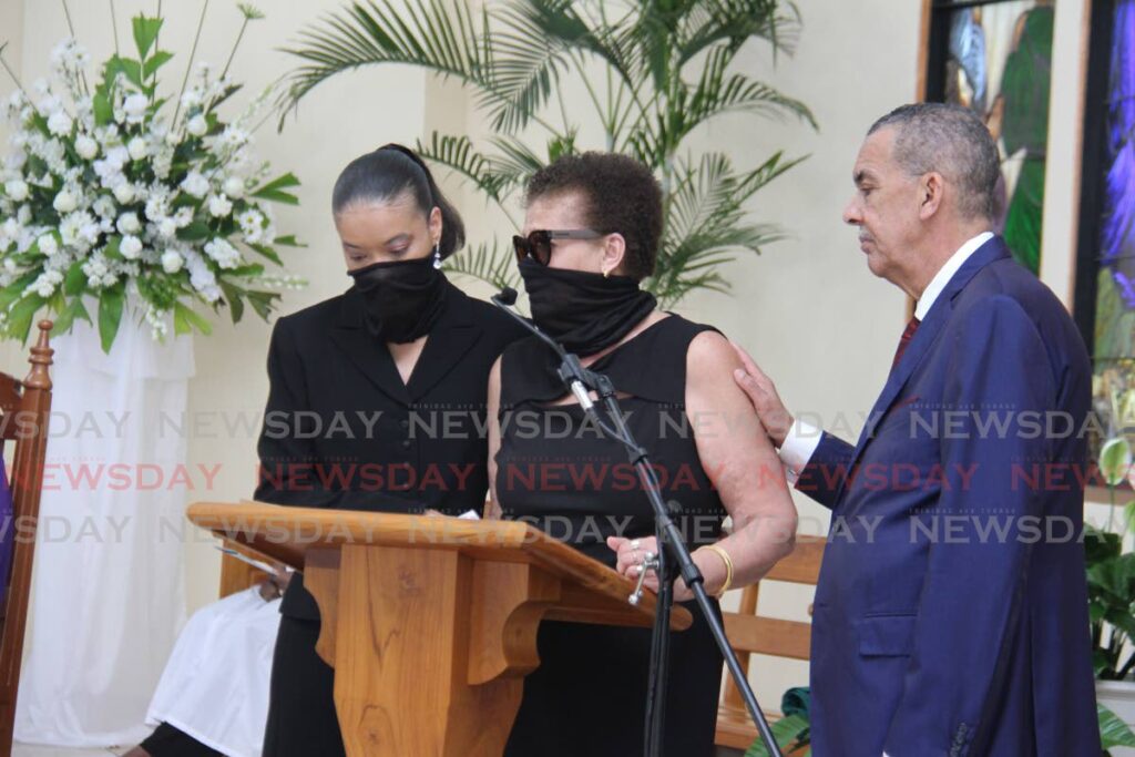 Former president Anthony Carmona comforts relatives as they speak about the life of his late father, Dennis Carmona, at the St Benedict's RC Church in La Romaine on Friday. - Photo by Marvin Hamilton