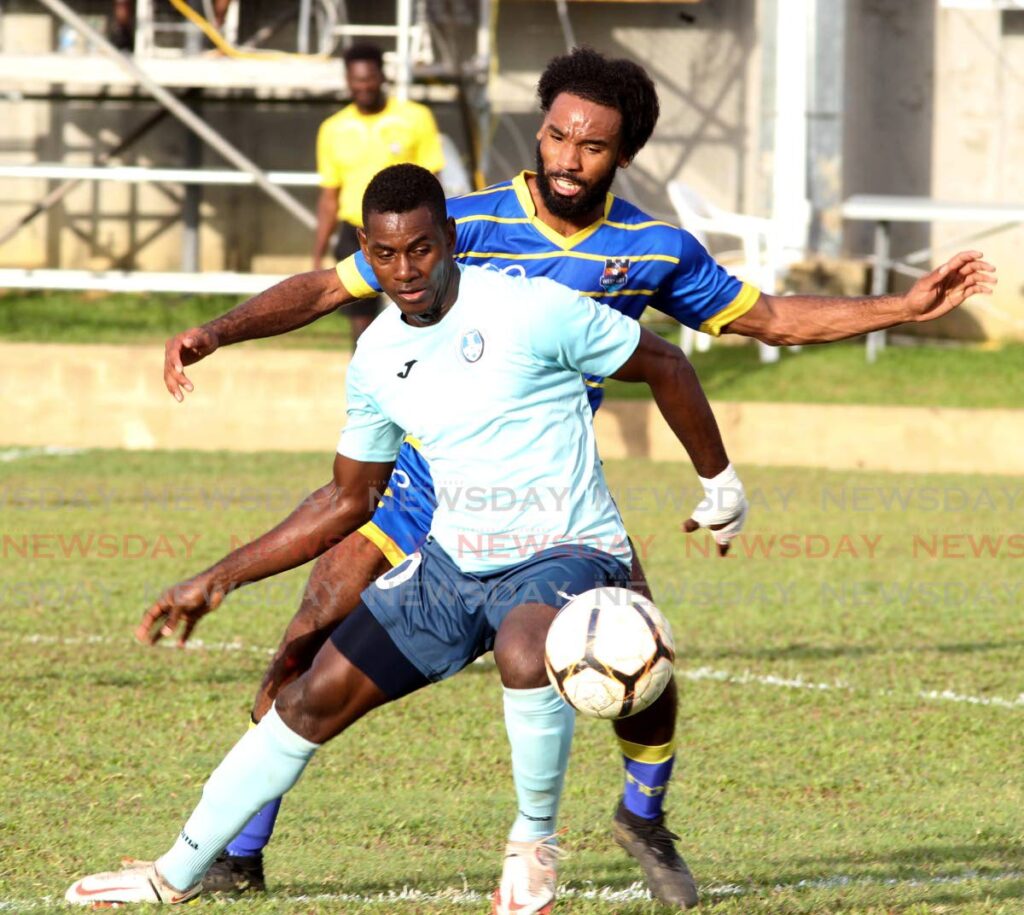 Joshua Evans of Real West Fort United, puts a tackle on Tyrese Bailey of Police FC (front), during an Ascension League match at the Police Barracks, St. James on Sunday. - Angelo Marcelle