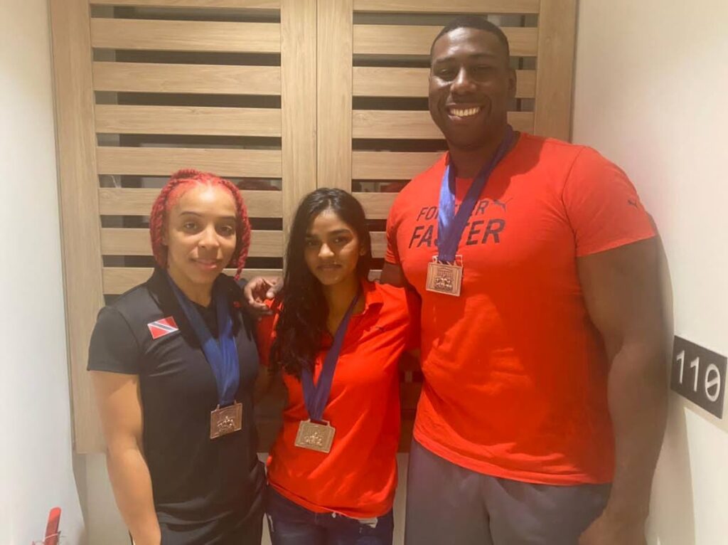 (L-R) Trinidad and Tobago boxers Tiana Guy (57kg), Ornella Walker (52kg) and Nigel Paul (92+kg) show off their medals earned at the 2022 Acropolis Cup held in Athens, Greece over the weekend.  Photo courtesy Reynold Cox