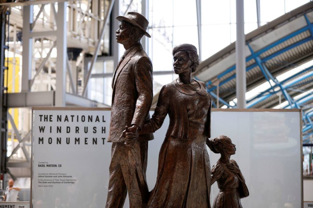 The National Windrush Monument unveiled at Waterloo Station in London, on June 22. The unveiling of the statue - of a man, woman and child in their Sunday best standing on top of suitcases will mark Windrush Day.  - AP Photo