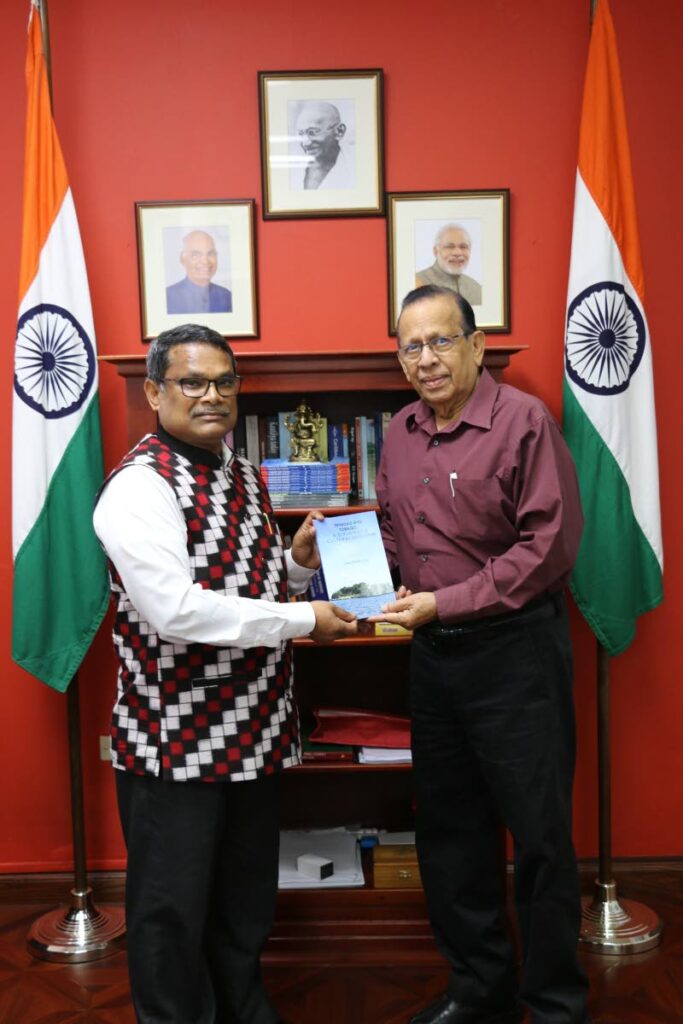 Prof Ramesh Deosaran presents his book - Dr Williams, the Man, His Mission - to outgoing Indian High Commissioner Arun Kumar Sahu last week. - Photo courtesy Indian High Commission