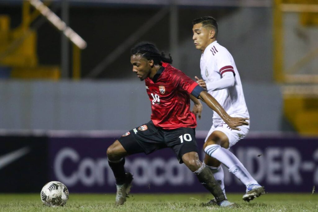 TT Under-20 captain Molik Khan (left) scored his team's second goal agaianst Suriname, on Thursday, during their Concacaf Under-20 Championship match , at the Estadio Olimpico Metropolitano, San Pedro Sula, Honduras. TT won 3-0. - TTFA Media