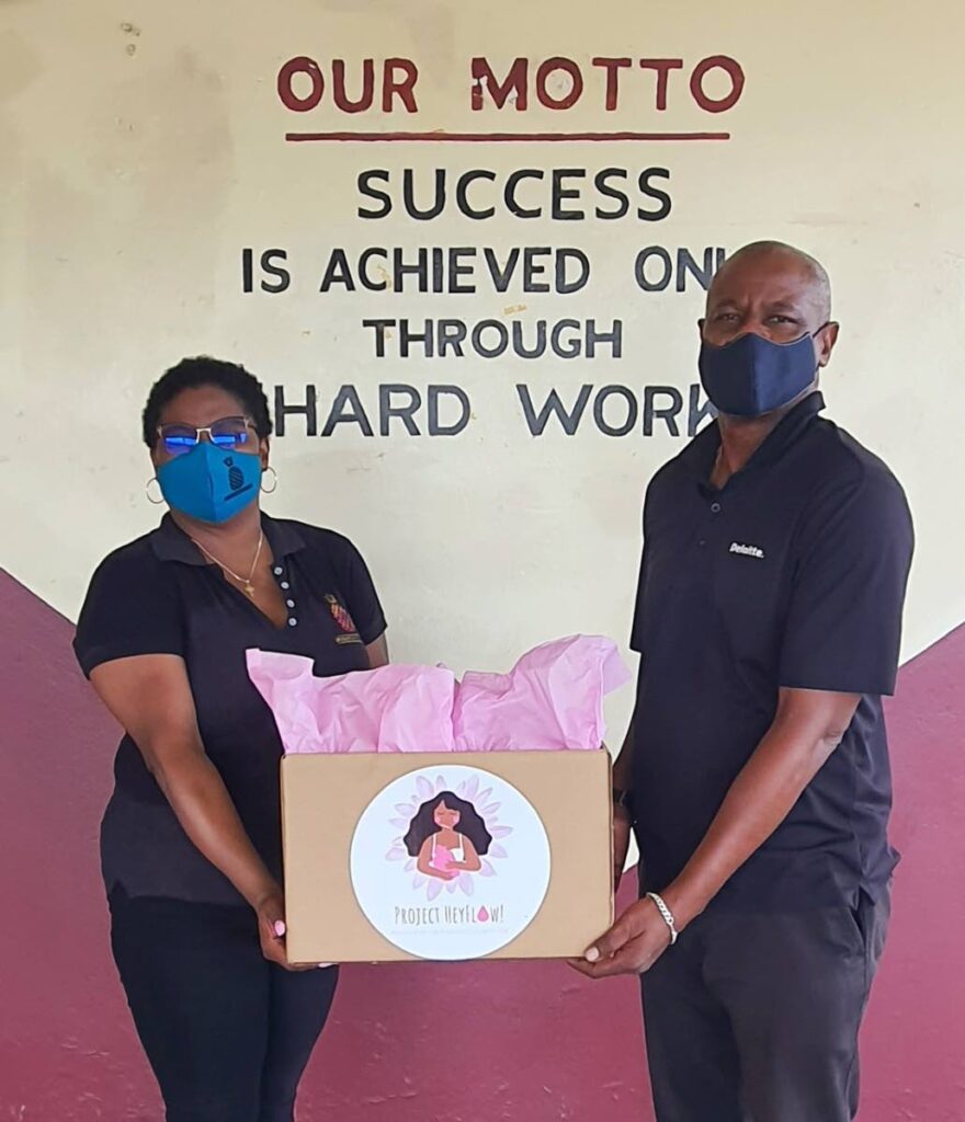 Pineapple Foundation’s operations officer, Lana Richardson-Shade presenting the principal of East Mucurapo Secondary School, Mr Phillip with a donation of sanitary napkins for students.  - 