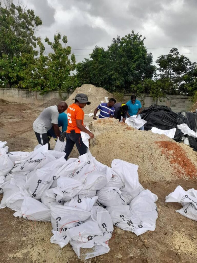 Workers at the Tunapuna Regional Corporations prepare sandbags for distribution  - 