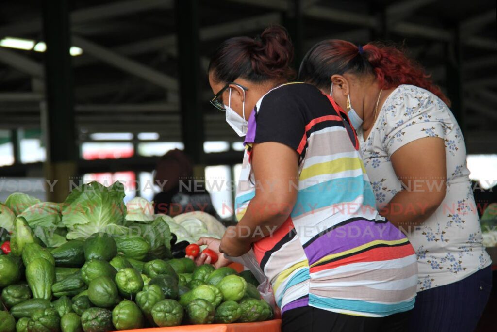 Customers select their produce at the Norris Deonarine Northern Wholesale Market, Macoya in this 2021 file photo. - AYANNA KINSALE