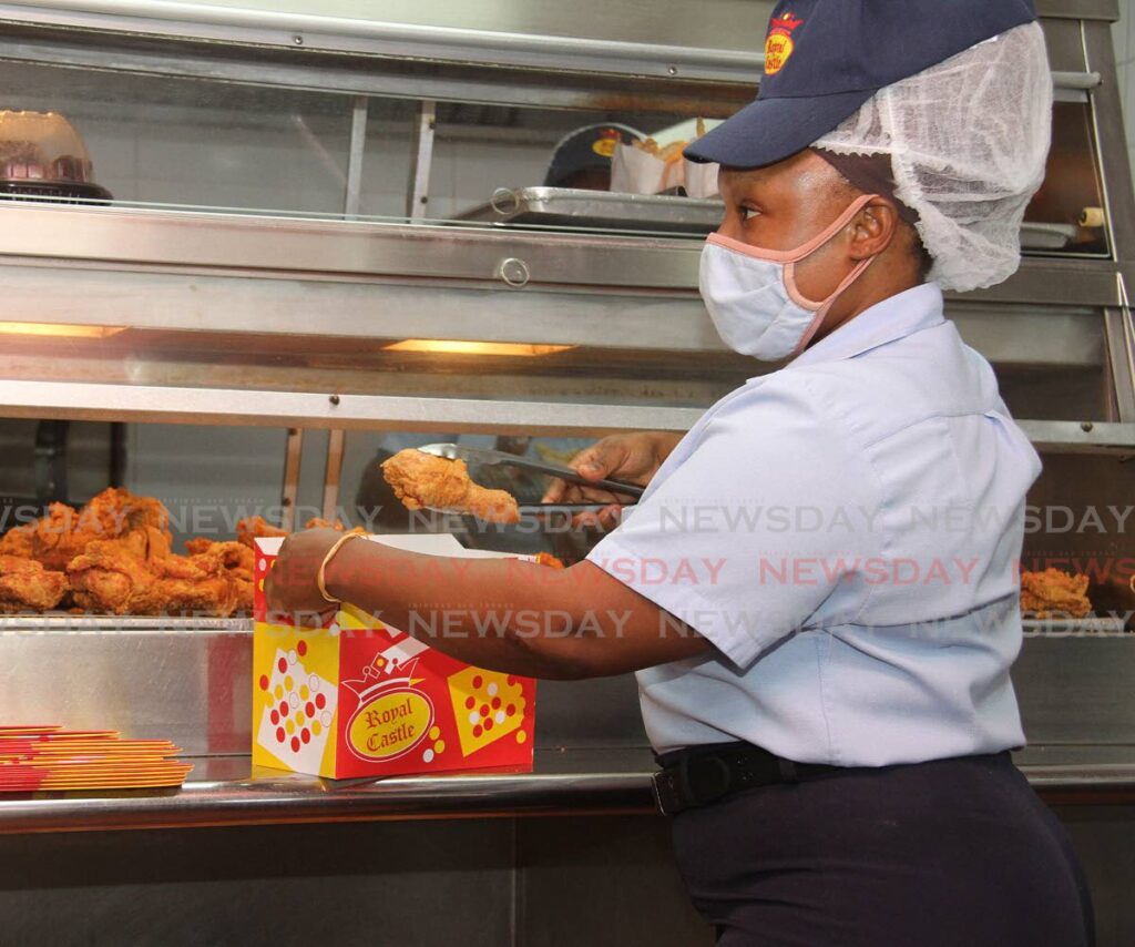 In this July 2021 file photo, Royal Castle employee Tanicka Brooks, packs a box for a customer at the Southern Main Road, Marabella branch. - File photo/Angelo Marcelle