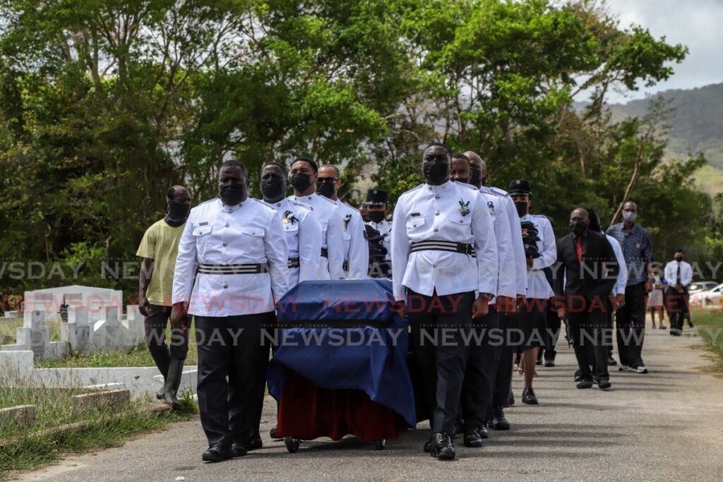 The body of PC Clarence Gilkes in carried for burial at the Tunapuna Public Cemetery on April 30. - JEFF K MAYERS