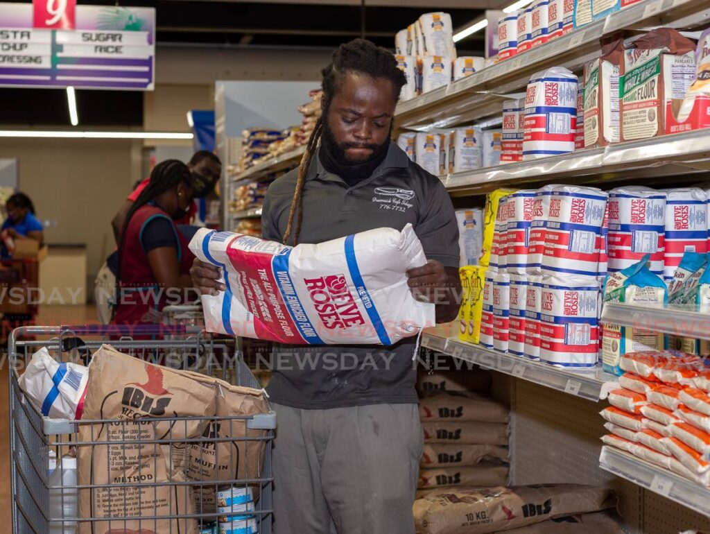 Hasani George of Whim, Tobago buys sacks of flour at Penny Savers, Carnbee in this file photo. The covid19 pandemic and the war in Ukraine have caused food prices to increase. - David Reid