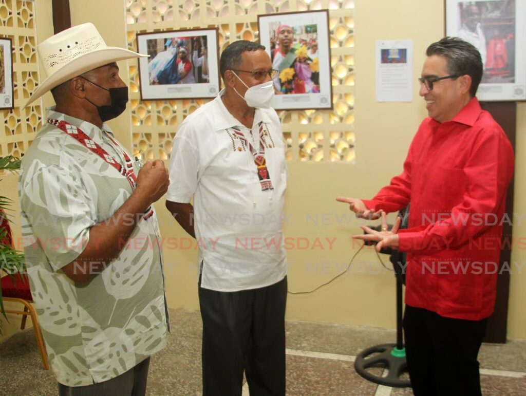 Chris Adonis, chief of the Santa Rosa First People's Community Ricardo Bharath-Hernandez, and Venezuelan Ambassador Alvaro Sánchez, chat at the photo exhibition of St John The Baptist at the Lopinot Community Centre.  - Angelo Marcelle
