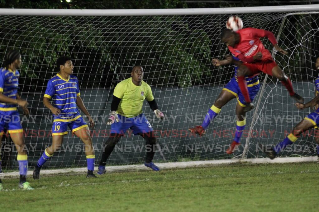Real West Fort United goalkeeper Dwayne Thomas look on as a La Horquetta Rangers player comes flying in with a header during their match at La Horquetta on June 24.  - Angelo Marcelle