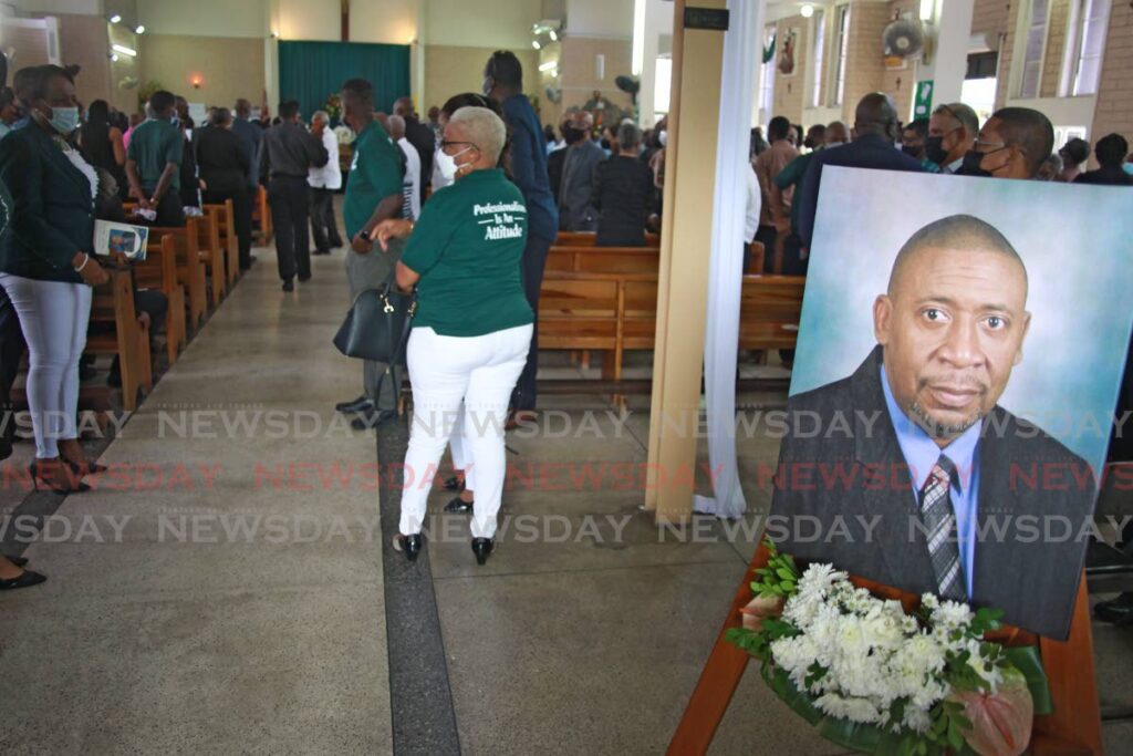 A portrait of David John-Williams is seen at the entrance to the St Paul’s RC Church, Southern Main Road, on Thursday, during the funeral for the former TTFA president.  - Lincoln Holder